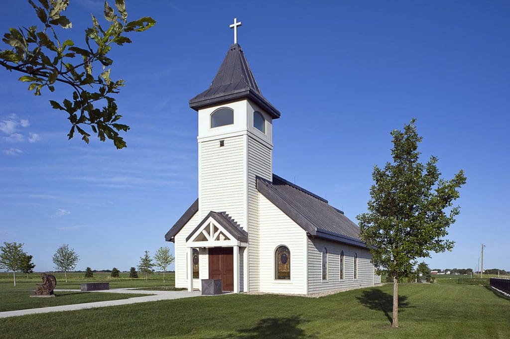 Little white chapel with gray roofing and windows in the top tower