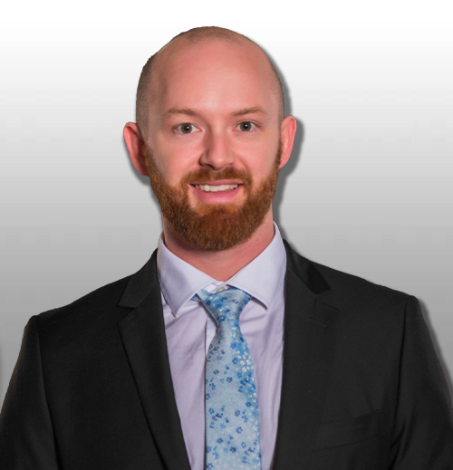 smiling bald man wearing a suit and time with a ginger beard