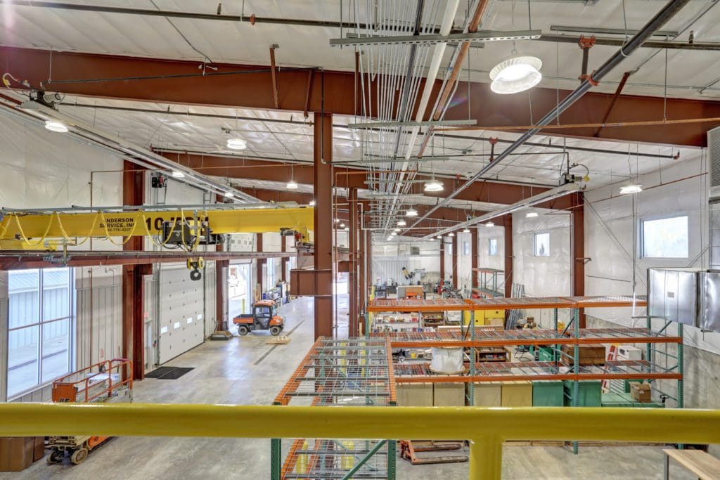 Interior of a warehouse with concrete floors and copper railing
